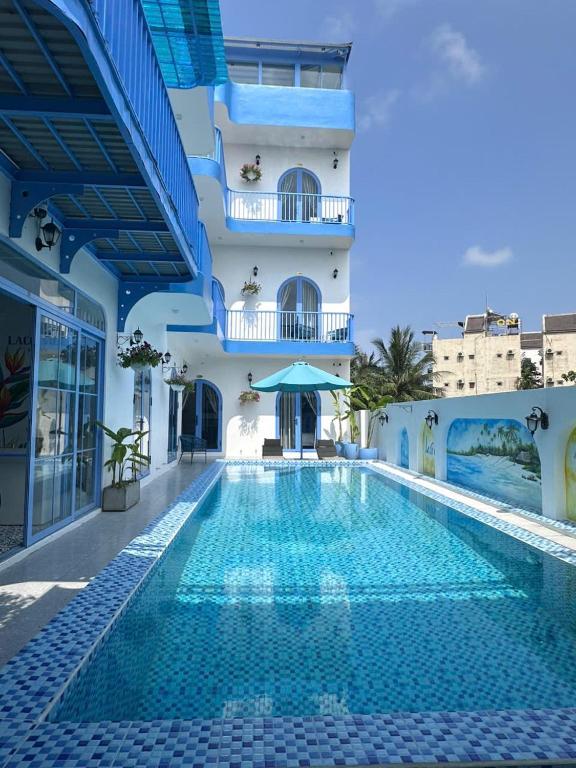 a hotel swimming pool in front of a building at Laco Villa in Danang