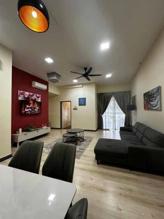 a living room with a couch and a table at VH HOMES l Imago Mall l 2BR Family Suite l Garden Direct Access in Kota Kinabalu
