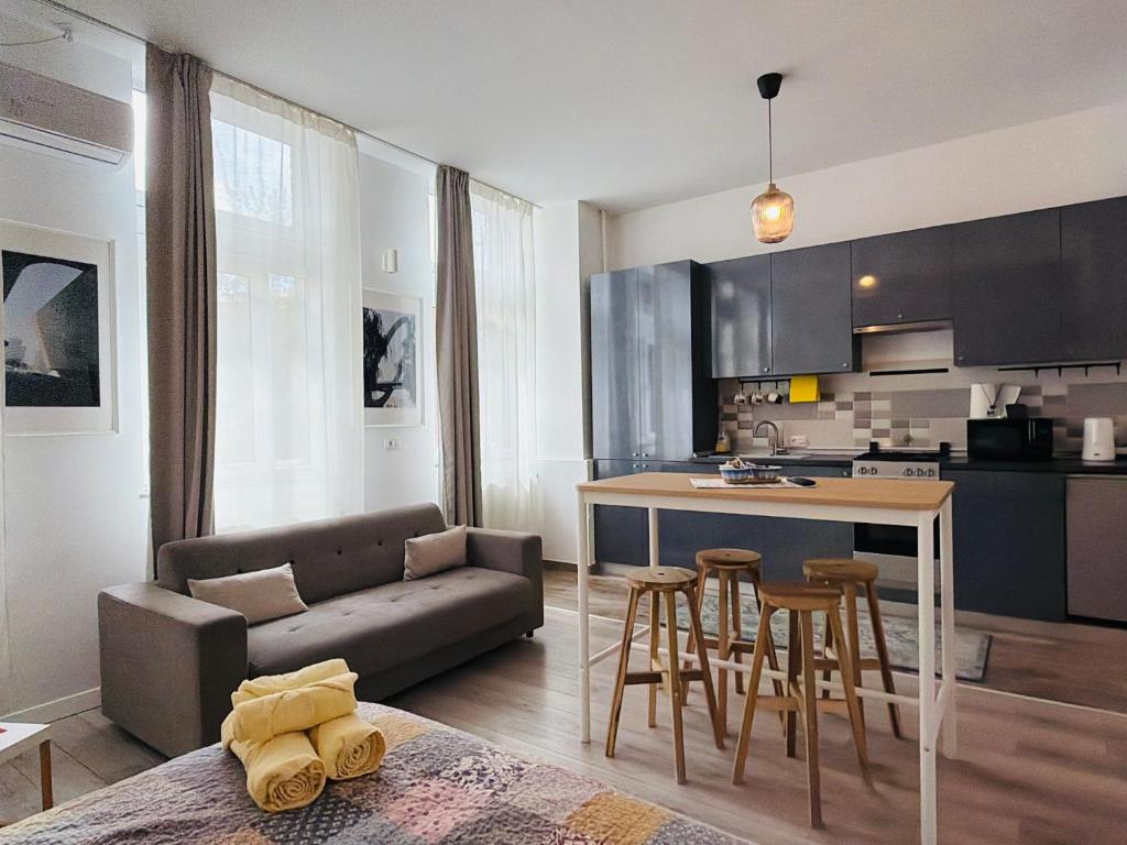 a kitchen and living room with a couch and a table at Sunny Studio Apartment in Iaşi