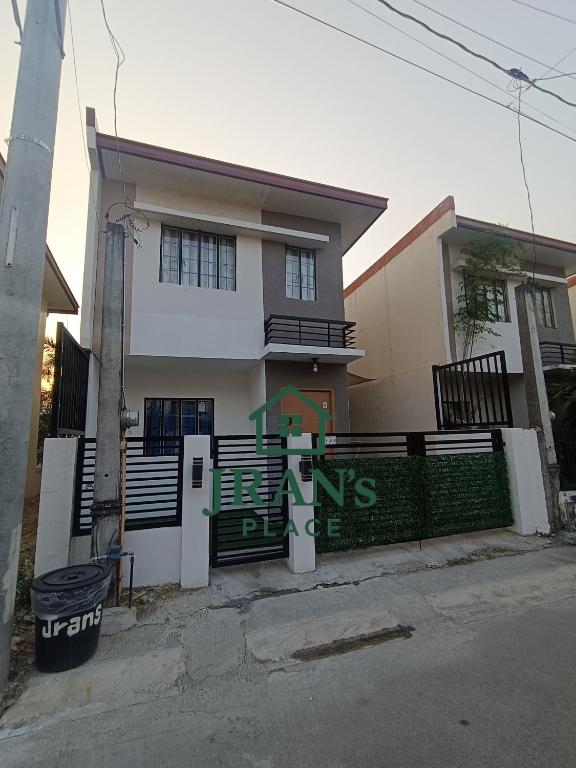 a house with a gate in front of it at JRAN's Place Home in Baliuag, Bulacan in Suliban