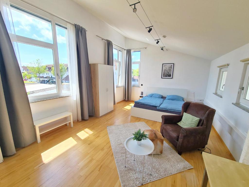 a living room with a bed and a couch at Apartment am Rohrbach in Friedrichshafen