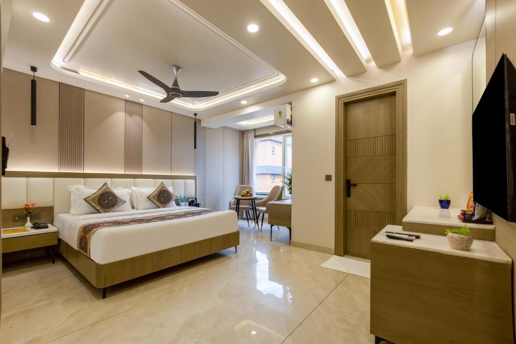 a bedroom with a bed and a living room at Holiday Homez, City Centre with Free Airport & Train Station Pickup in New Delhi