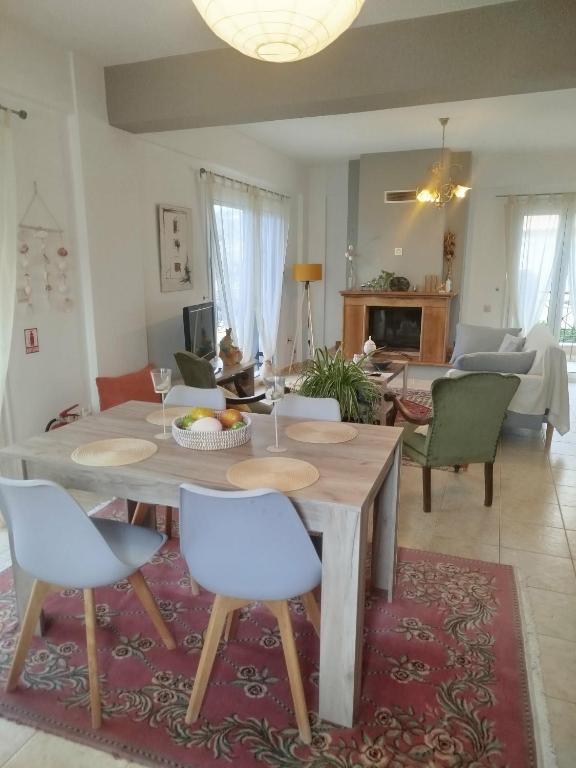 a living room with a wooden table and chairs at Paulina's House in Politika