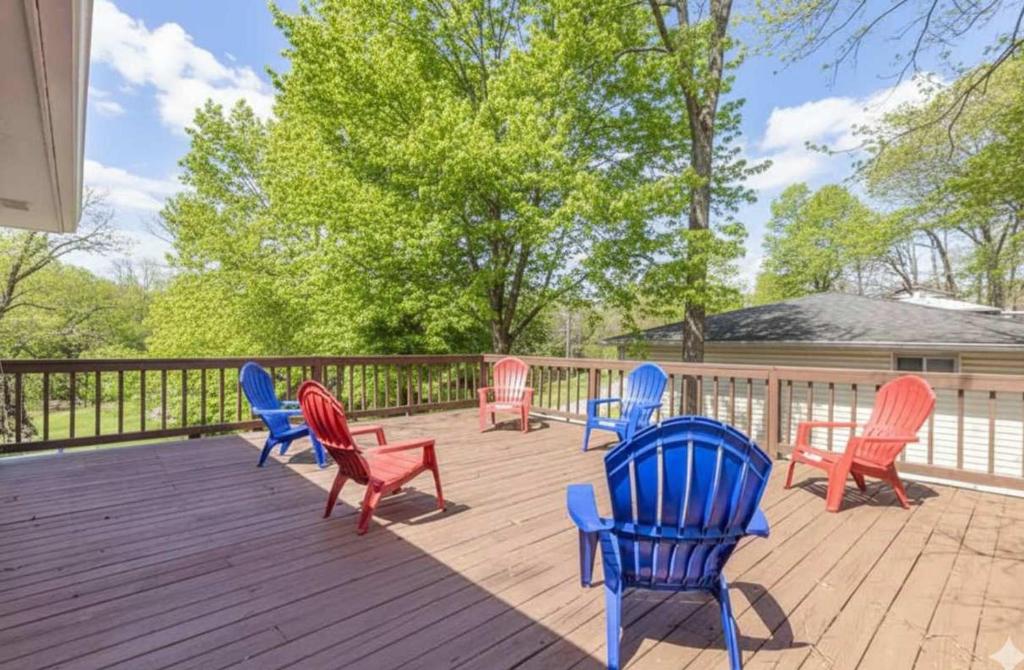 a group of colorful chairs sitting on a deck at Quiet Getaway, Travis' Place! Affordable Location in Rossville