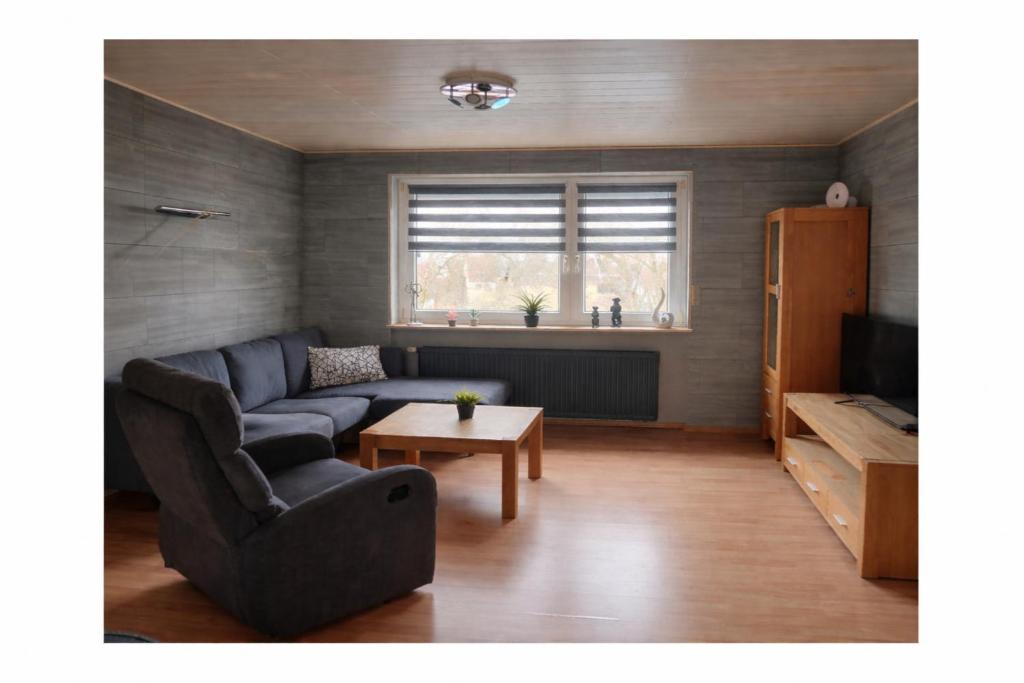 a living room with a couch and a table at Hebels Auszeit in Heimbach