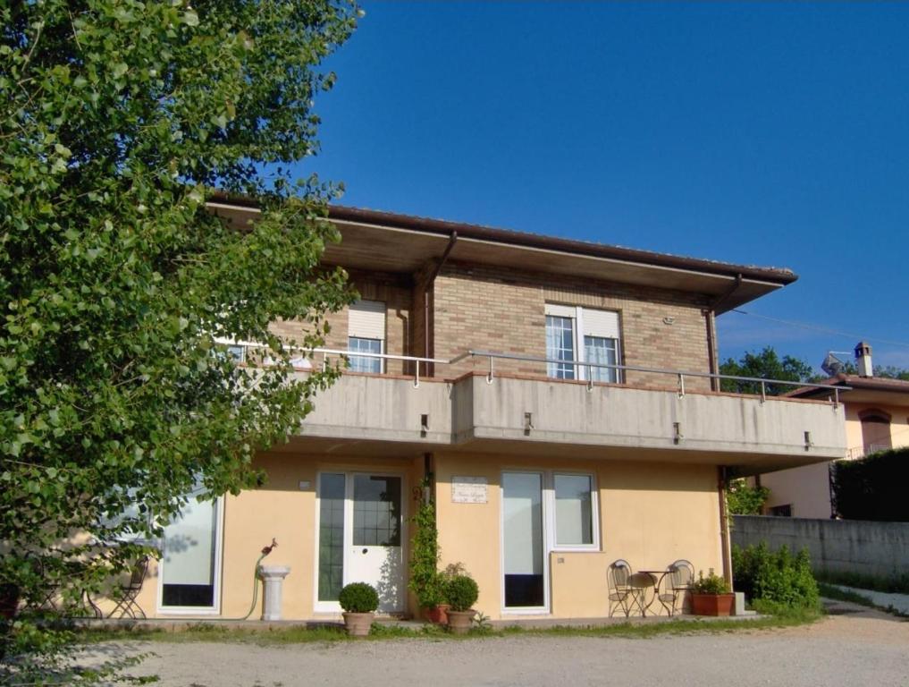 a house with a balcony on the side of it at B&B Nuova Loggia in Fabriano