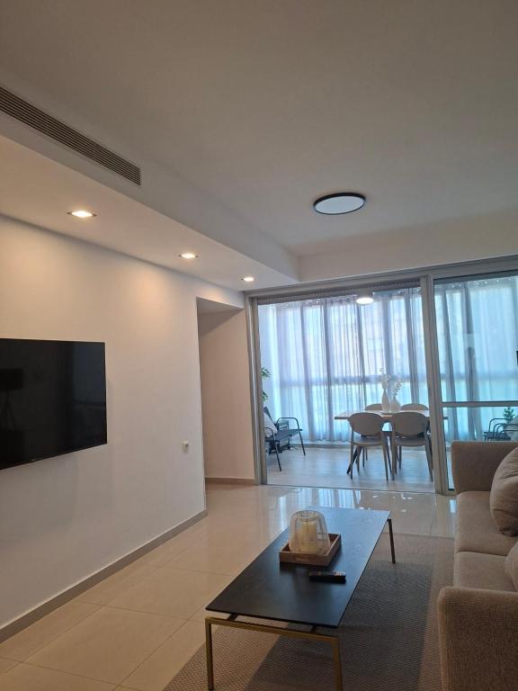 a living room with a couch and a table at Histadrout street 3 bedrooms central Ashdod in Ashdod