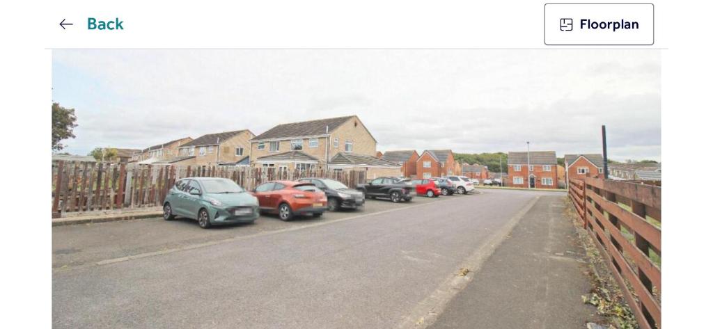 a row of cars parked on the side of a street at Beamish apartment in Pelton