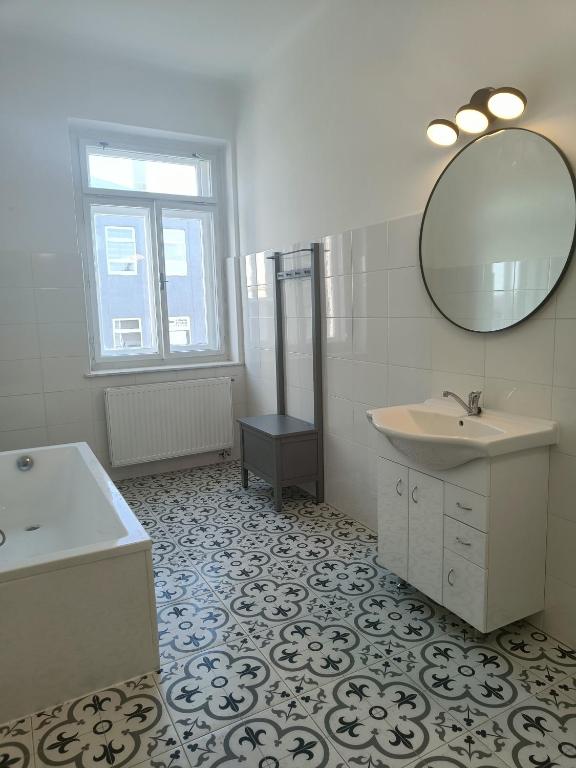 a bathroom with a sink and a mirror at Apartmán Procyon in Prostějov