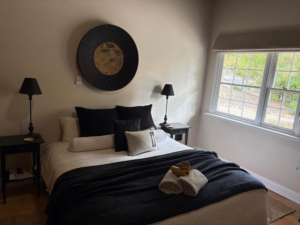 a bedroom with a large bed with two shoes on it at Roscrow Heritage Retreat in Clare