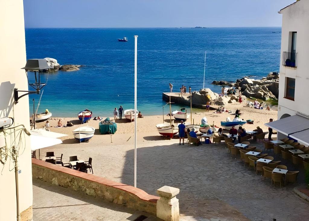 a group of people on a beach with the ocean at Calella-Port Bo · Sun Sea Unique Character in Calella de Palafrugell