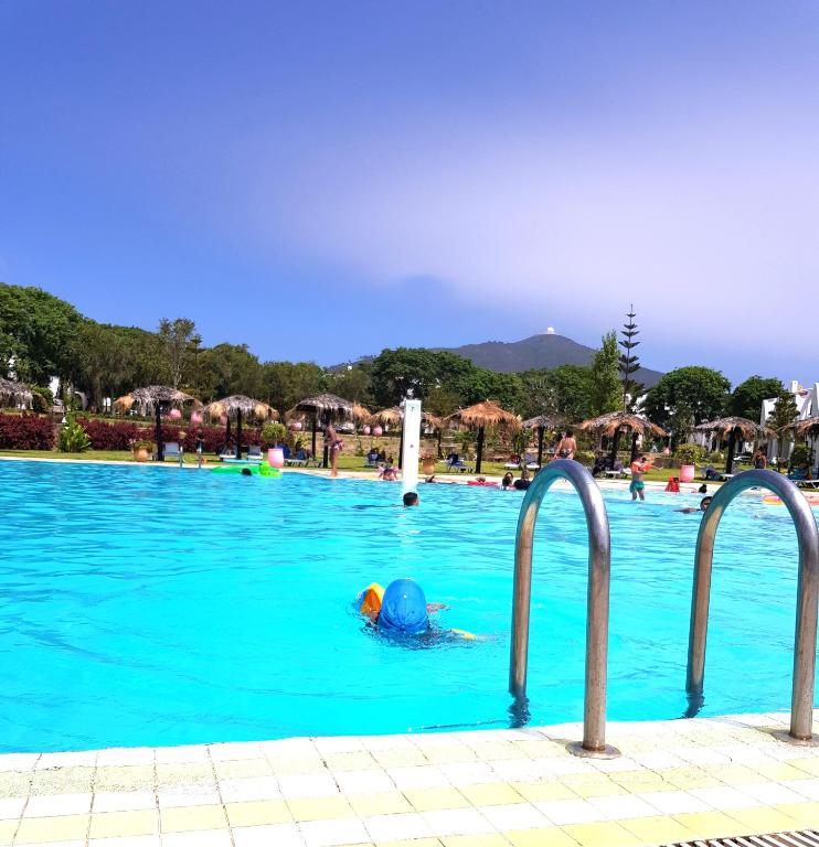 a person in a swimming pool at a resort at Maison à Cabonegro in Cabo Negro