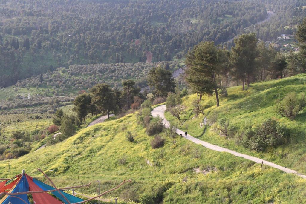 a tent on the side of a hill with a road at חדשה בעתיקה - צפת in Safed