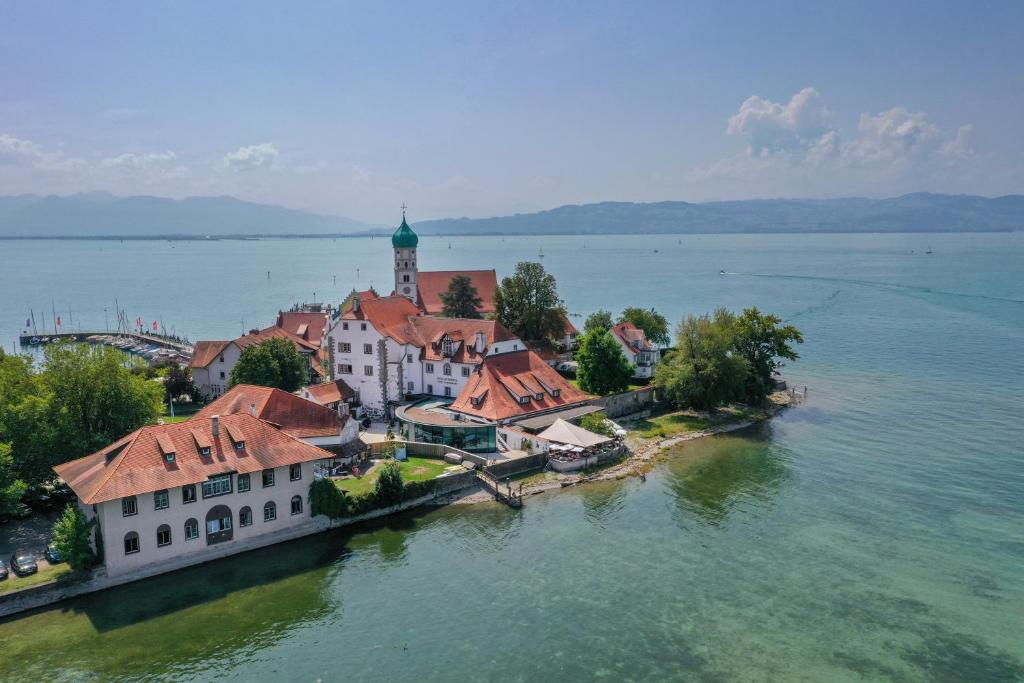 an island in the middle of a large body of water at Schloss Hotel Wasserburg in Wasserburg