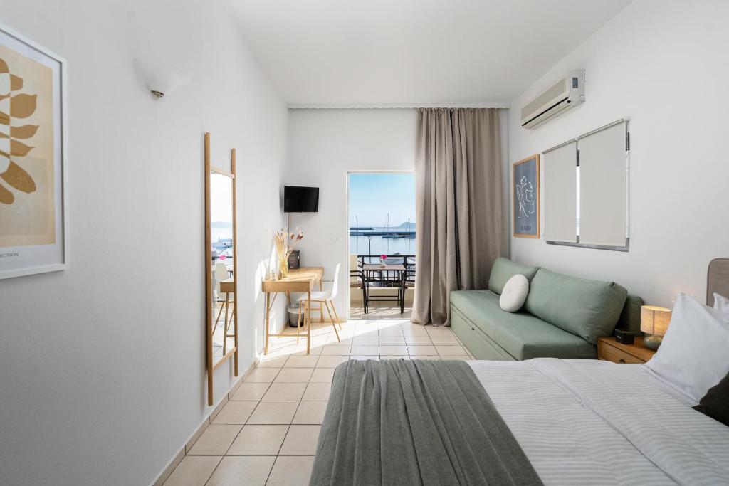 a hotel room with a bed and a couch at Flisvos in Sitia