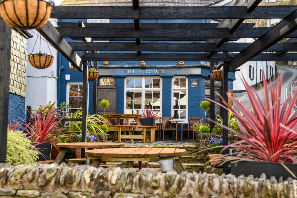 a patio with a table and chairs in front of a restaurant at The Crown Hotel in Lynton