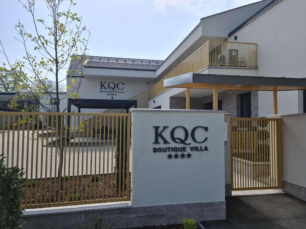 a building with a fence and a kc boutique villa at KQC Boutique Villa in Balatonlelle