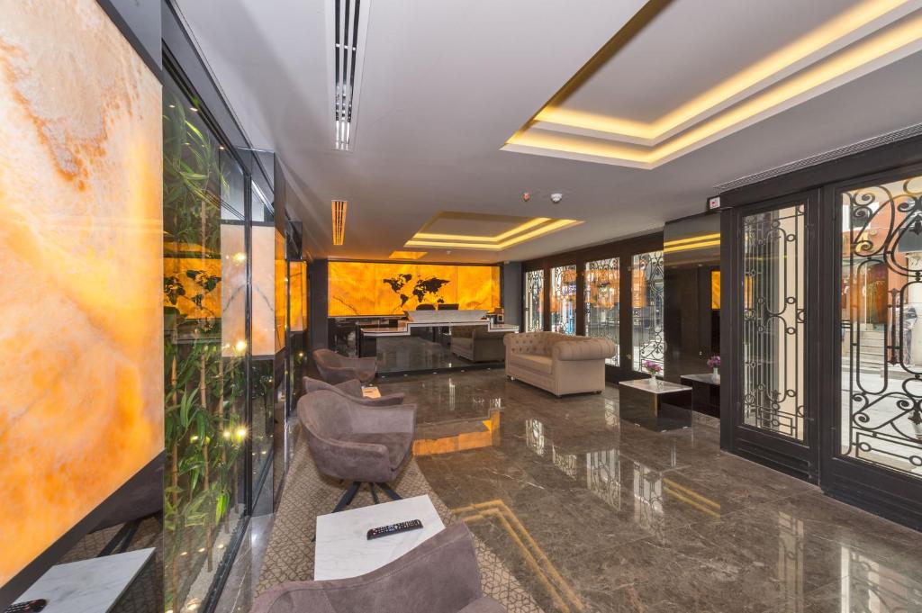 a lobby with a living room with a couch and chairs at Hotel Genova Istanbul Old City in Istanbul