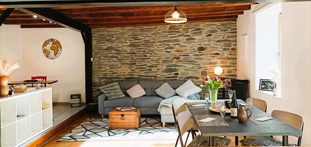 a living room with a couch and a table at L'Échappée en Sandales in La Gacilly