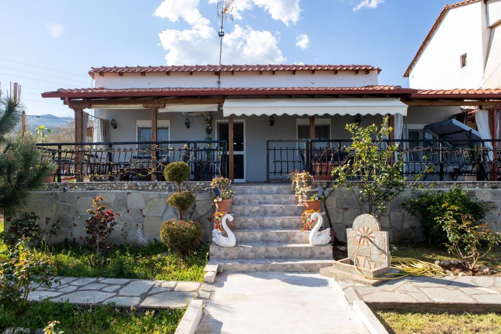 a house with stairs in front of it at Casa dei fiori in Asprovalta