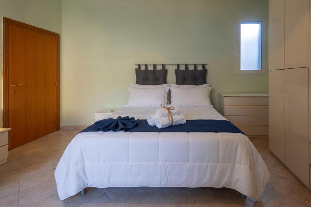 a bedroom with a large bed with a stuffed animal on it at Dimora Dina Guglionesi in Guglionesi