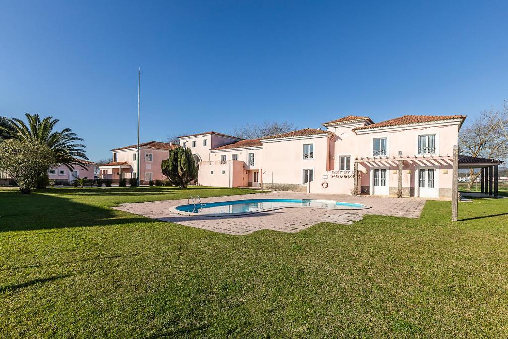 a large house with a swimming pool in the yard at HI Ofir – Pousada de Juventude in Esposende