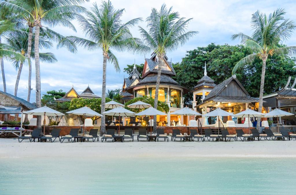 a resort on the beach with chairs and umbrellas at Dara Samui Beach Resort Adult Friendly, Chaweng in Chaweng