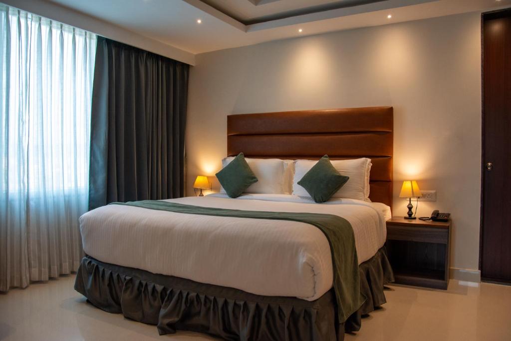 a bedroom with a large bed in a room at Hotel De Blossom in Guwahati