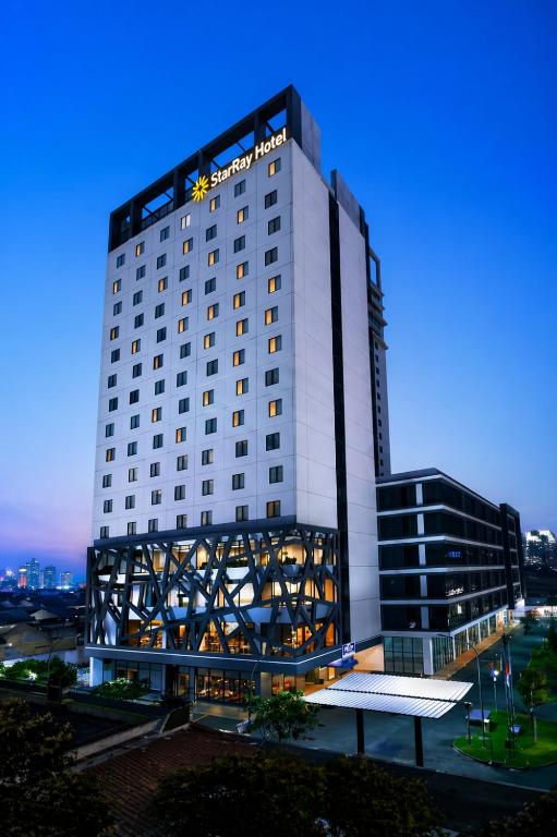 a rendering of a hotel building at dusk at StarRay Hotel Jakarta Kebayoran in Jakarta