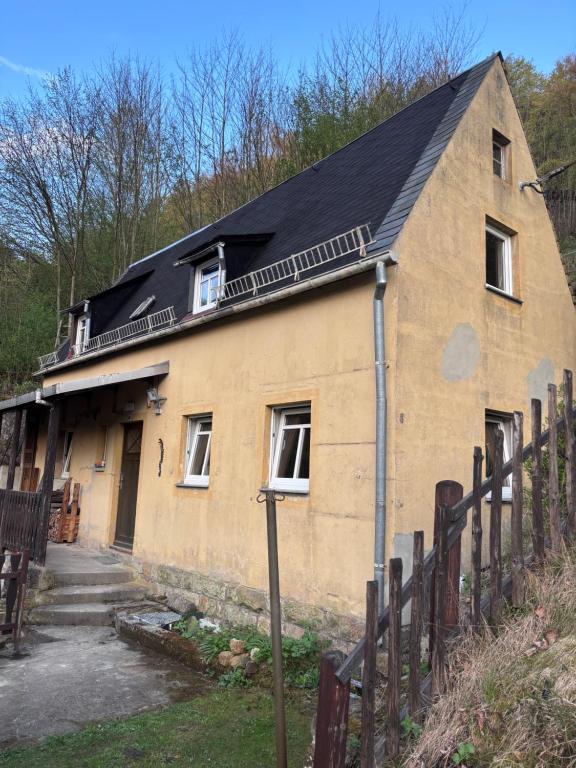 an old brick house with a black roof at Haus Abendsonne in Bad Schandau