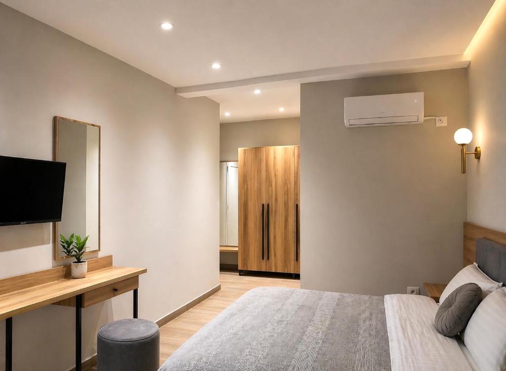 a bedroom with a bed and a flat screen tv at Mili Hotel in Berat