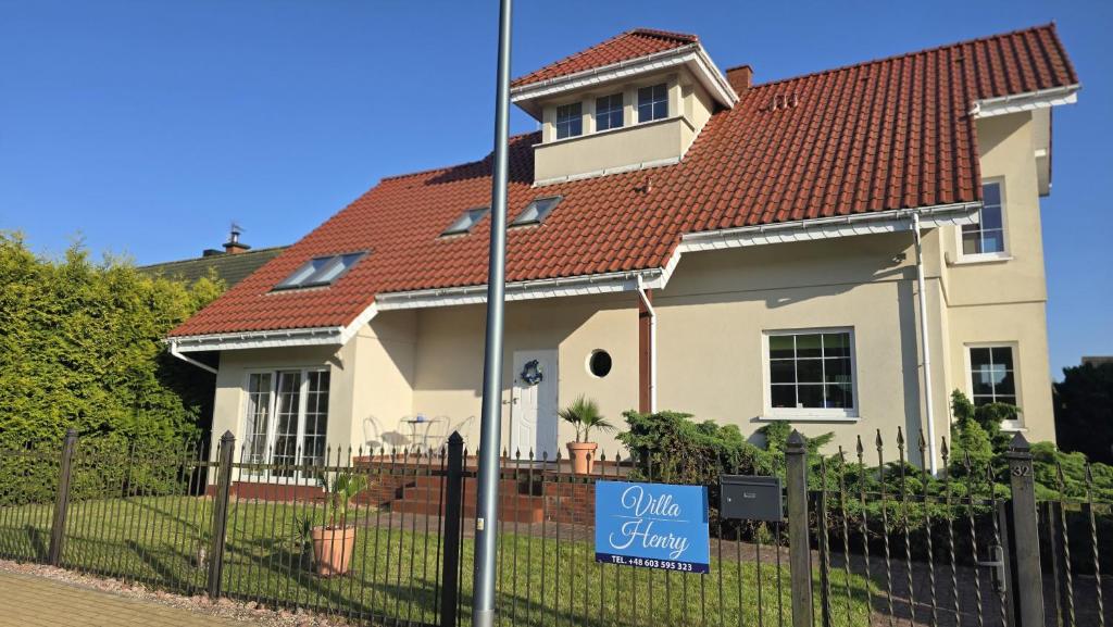 a house with a sale sign in front of it at Villa Henry in Grzybowo