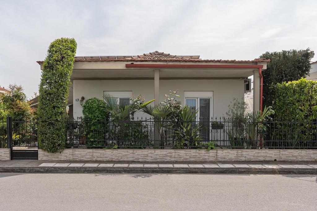 a house with a black fence in front of it at Olympus & Sea Harmony in Katerini