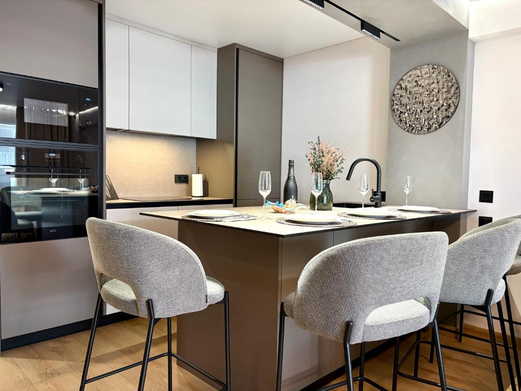 a kitchen with a island with chairs and a counter top at Sunny Waves Apartment in Cullera