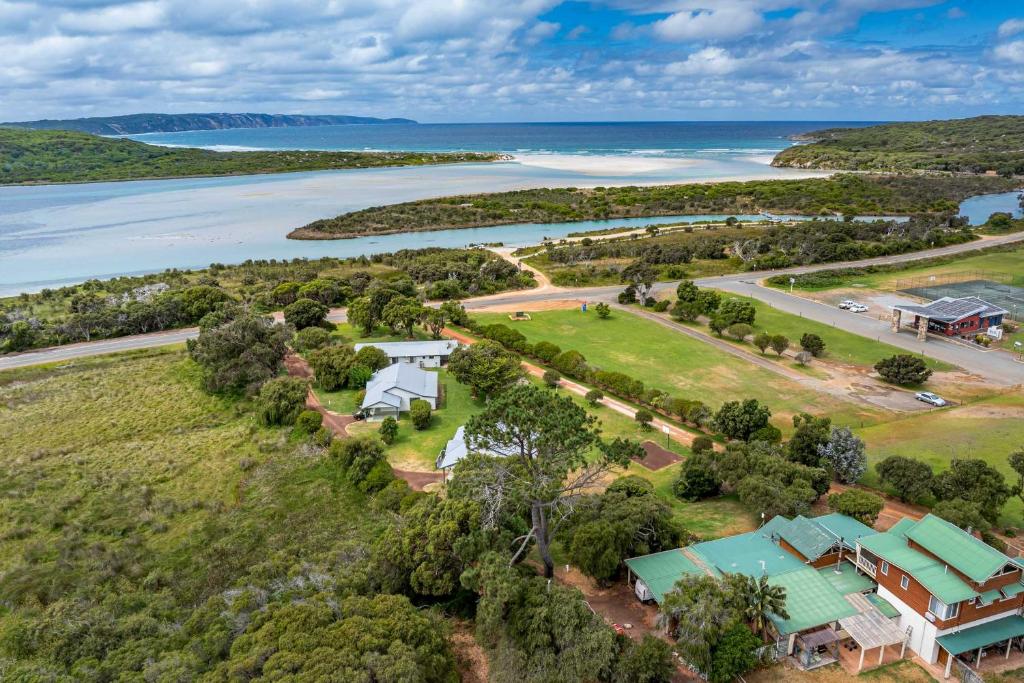 an aerial view of a house on a hill next to the water at Surfside Ocean Beach Denmark Holiday Accommodation in Denmark