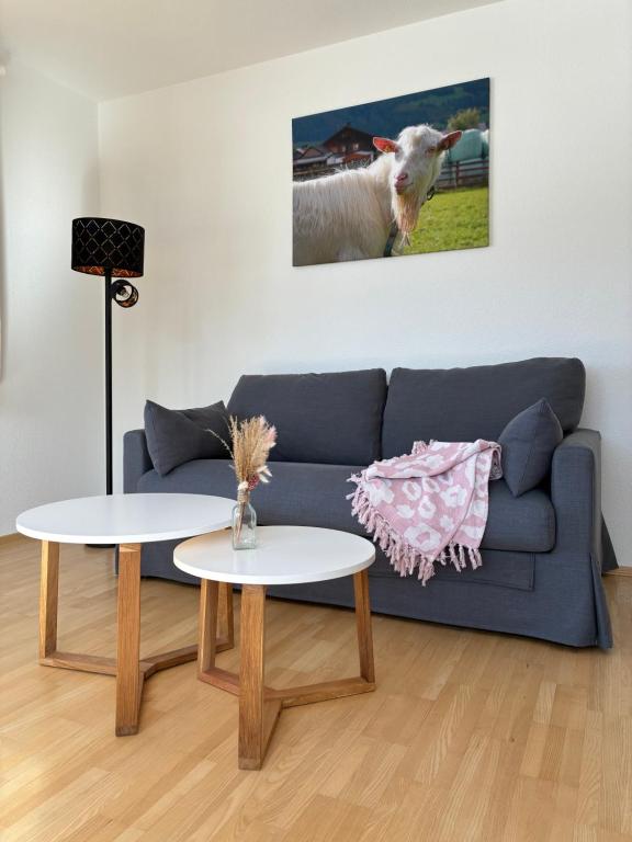 a living room with a couch and a cow on the wall at a feines Platzl in Asch