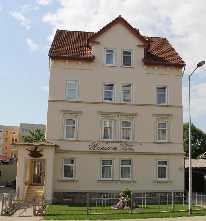 a large white building with a red roof at Pension Der kleine Nachbar in Gotha