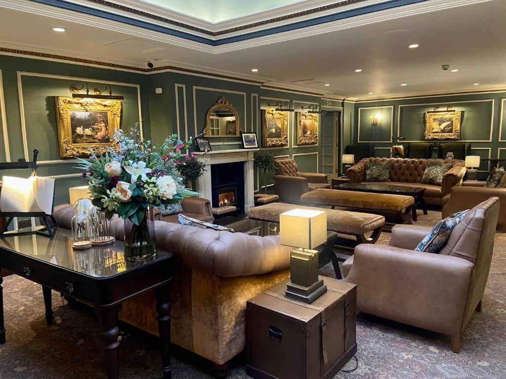 a living room filled with furniture and a fireplace at Swan's Nest Hotel in Stratford-upon-Avon