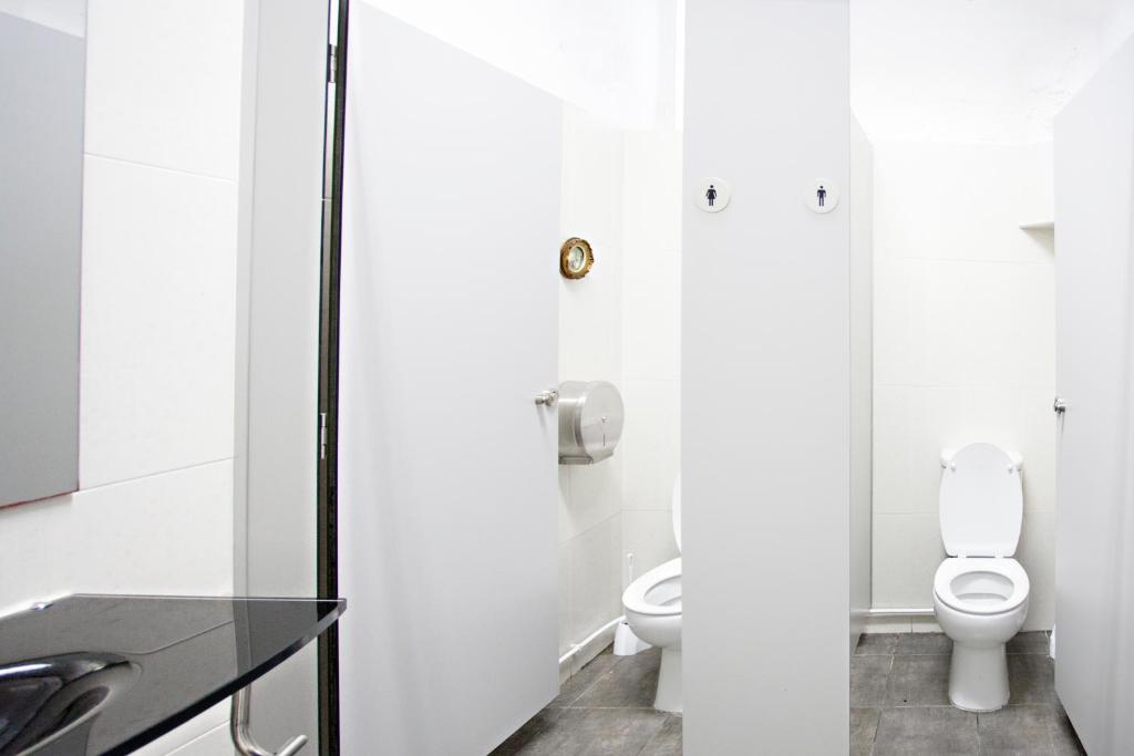 a bathroom with a toilet and a sink at Baixa Terrace Hostel in Faro