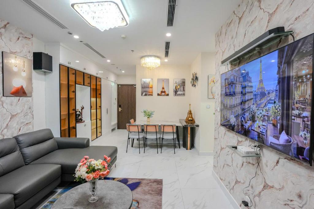 a living room with a couch and a tv at Shi House -Modern Luxury 2BR Apartment BE3 Beverly in Ấp Thạnh Lộc