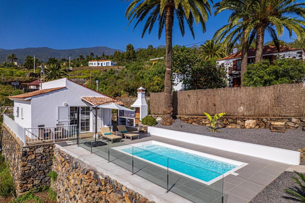 an external view of a villa with a swimming pool at Casa Yuliana in Tijarafe