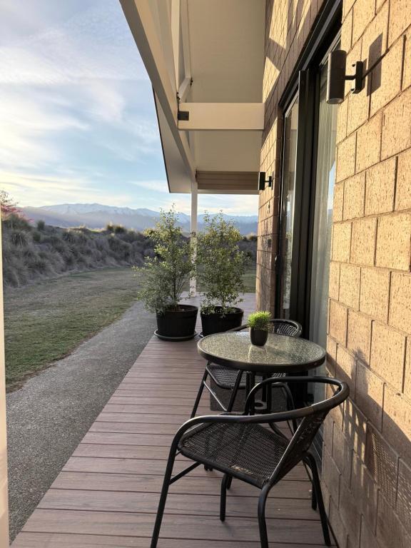 a patio with two chairs and a table on a porch at Guesthouse A in Twizel