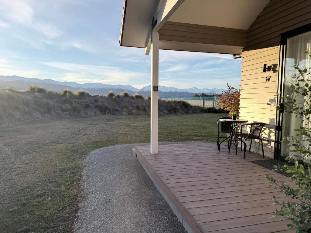 a porch of a house with a table and chairs at Guesthouse B in Twizel
