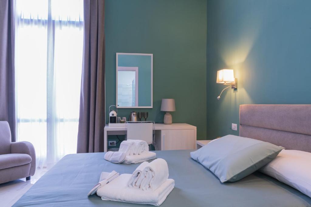 a bedroom with two towels on a bed at Le Suite in Crotone