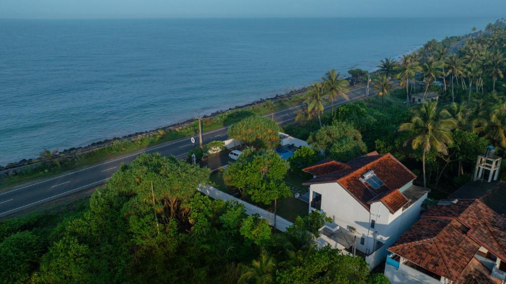 an aerial view of a house next to the ocean at Villa Oceana By Heritage in Hikkaduwa