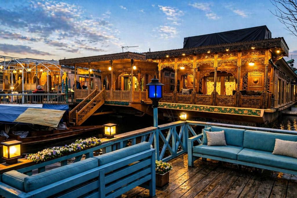 a building with a blue couch on a deck at The Heritage Group of Houseboats in Srinagar