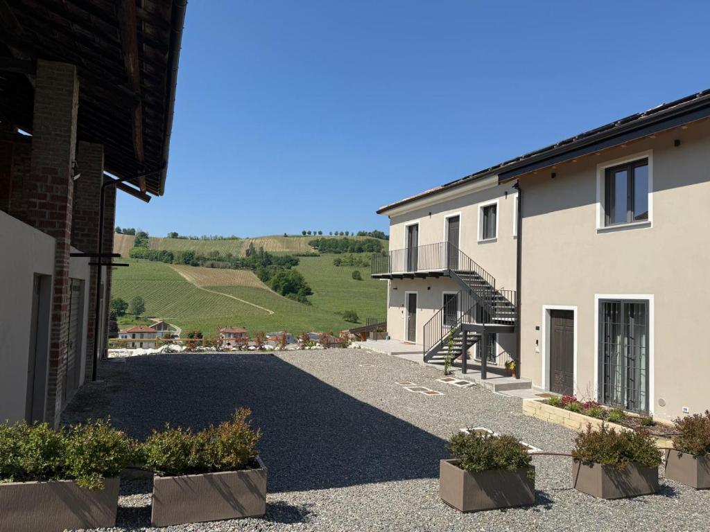 a driveway in front of a building with a view at NessunConfine Casa Sara in Santa Giuletta