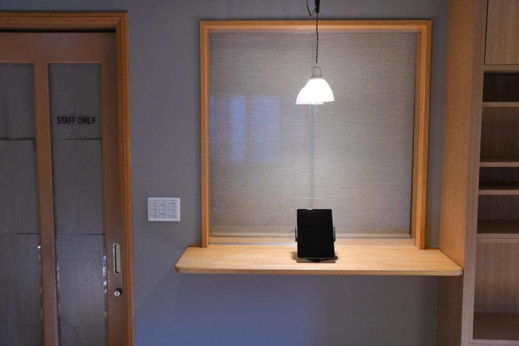 a window with a phone sitting on top of it at べっどぷらす in Wakkanai