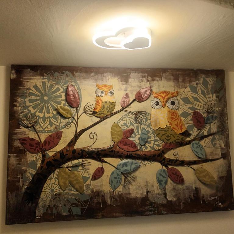 a painting of three owls on a tree branch at Kiutaro 2 in Yuli