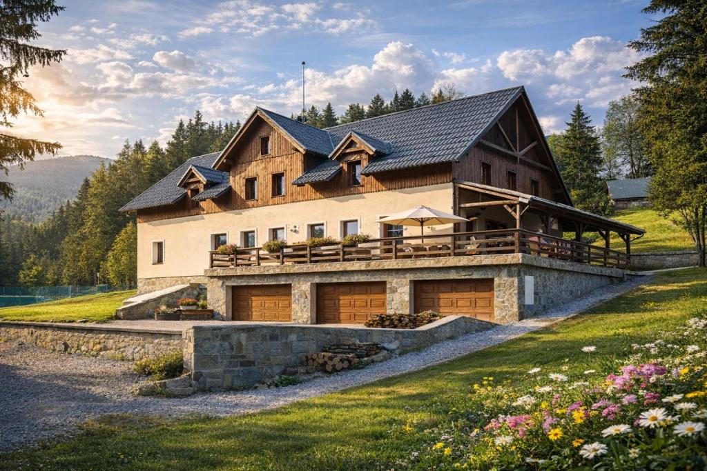 a large house with a gambrel roof at Penzion Čekanka in Strážné